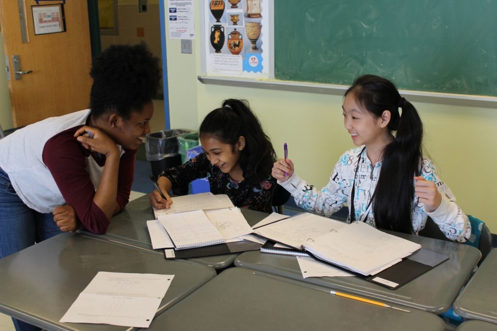 Fatima, a BEAM 7 alum now on a pre-med track at Manhattan College, works with Faoziah and Yilin during Open Math Time.