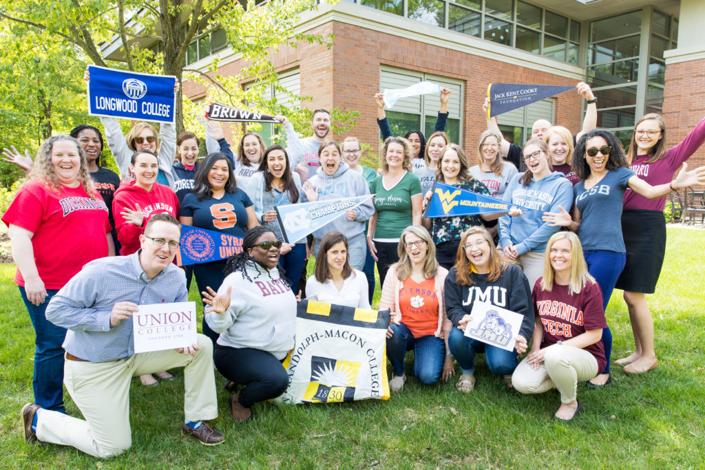 Foundation staff celebrate College Signing Day with college shirts and banners representing their alma maters.