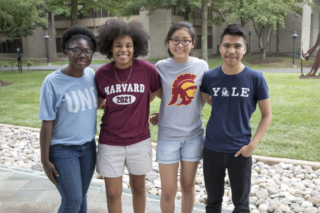 Four Cooke Scholars stand in a group outside.